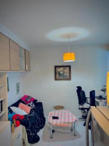 a living room with a couch and a table at Cozy Poolside Condo Near BTS All Amenities in Sathani Ban Hua Mak