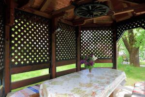 a vase of flowers sitting on a table in a pavilion at Guest House Sveti Marko Gacka in Otočac +18 photos