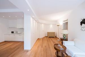 a living room with a white couch and a table at LHP Suite Santa Margherita in Santa Margherita Ligure