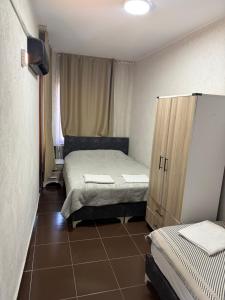 a small bedroom with two beds and a cabinet at Sunrise Hotel in Antalya +13 photos