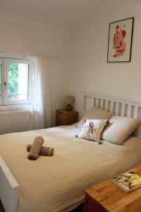 a bedroom with a bed with a stuffed animal on it at Maison de la Craffe in Francs
