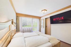 a bedroom with two beds and a sign on the wall at Suite with Mountain View near Saas-Fee in Saas-Almagell