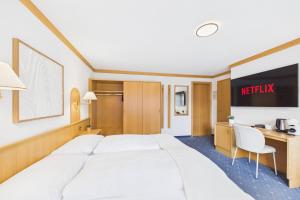 a hotel room with a bed and a desk at Suite with Mountain View near Saas-Fee in Saas-Almagell