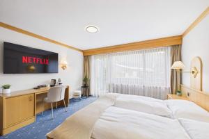 a hotel room with a bed and a desk at Suite with Mountain View near Saas-Fee in Saas-Almagell +11 photos