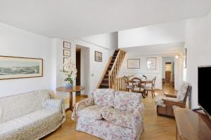 a living room with a couch and chairs and a table at Villa Ponzio in Genoa