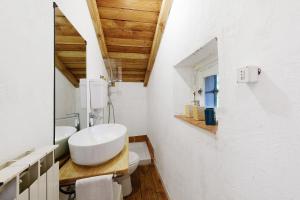 a white bathroom with a sink and a toilet at Villa Ponzio in Genoa +33 photos