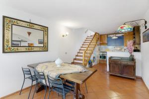 a kitchen and dining room with a table and chairs at Villa Ponzio in Genoa
