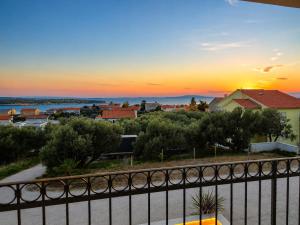 a view of a sunset from a balcony at Villa Lumia in Banjol
