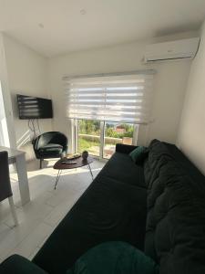 a living room with a black couch and a chair at Smolović Luxury Apartments Herceg Novi-Sea View,Free Parking in Zelenika
