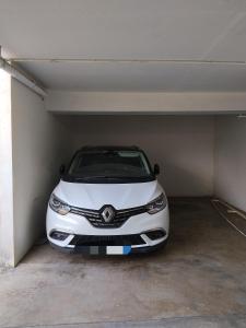 a white car parked in a garage at Résidence Louis in Saint-Denis