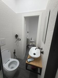 a bathroom with a toilet and a sink in it at B & B Yaya in Taranto