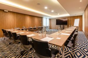 a large conference room with a long table and chairs at TURIM Lisboa Hotel in Lisbon
