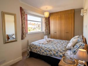 a small bedroom with a bed and a window at Tharsh Peaceful Escape Double Room with Shared Bathroom in Coundon