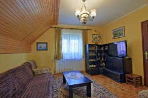 a living room with a couch and a tv at Guest House Sveti Marko Gacka in Otočac