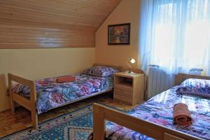 a bedroom with two beds and a window at Guest House Sveti Marko Gacka in Otočac