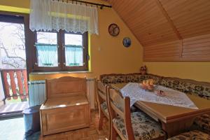a dining room with a table and a couch at Guest House Sveti Marko Gacka in Otočac