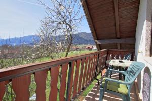 a porch with a table and chairs on a balcony at Guest House Sveti Marko Gacka in Otočac