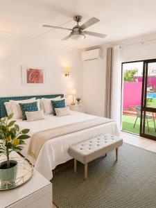a bedroom with a large bed with a ceiling fan at Vila Graciosa - Tranquility Oasis in Lagos