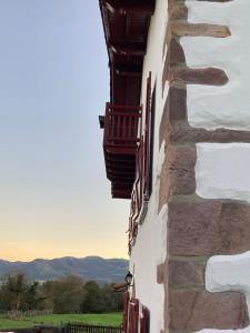 a building with balconies on the side of it at Maison chulubitenia in Irouléguy