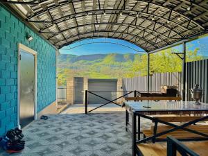 a patio with a table and a view of mountains at Quba Villa in Quba
