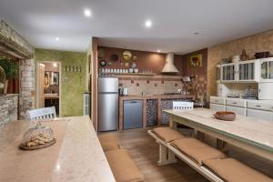 a kitchen with a table and chairs and a refrigerator at Casa Karnevali in Žminj