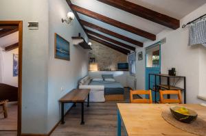 a living room with a bed and a table at Casa Karnevali in Žminj +86 photos