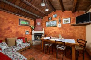 a living room with a table and a couch at Casa Karnevali in Žminj