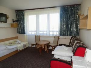 a room with two beds and a table and a window at Orwsnoch in Mielno