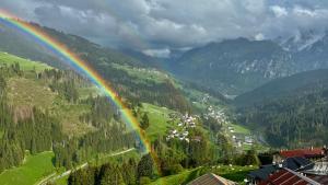 a rainbow in the middle of a valley with trees at Casa vacanze tortoi in Candide