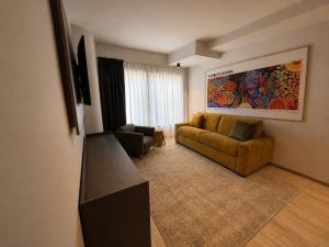 a living room with a couch and a table in a room at Best Quality Hotel Politecnico in Turin