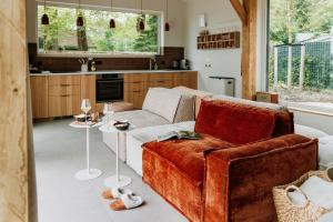 a living room with a couch and a table at Boshuis Haen in Ermelo