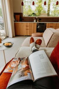 a person laying on a bed reading a book at Boshuis Haen in Ermelo +41 photos