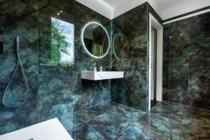 a bathroom with a sink and a mirror at Cozy Loft near MXP AIRPORT & RHO FIERA - 4 GUESTS - Parking FREE in Legnano
