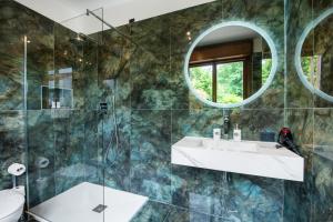 a bathroom with a sink and a mirror at Cozy Loft near MXP AIRPORT & RHO FIERA - 4 GUESTS - Parking FREE in Legnano +9 photos