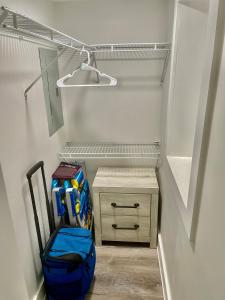a walk in closet with a blue bag and a drawer at Lil' Beach Getaway in Jacksonville Beach