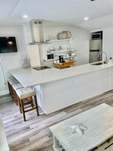 a kitchen with a white counter top and a table at Lil' Beach Getaway in Jacksonville Beach