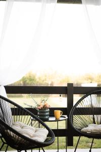 two chairs sitting on a porch with a table at Veseli svet-Zvizdar,Ub in Ub