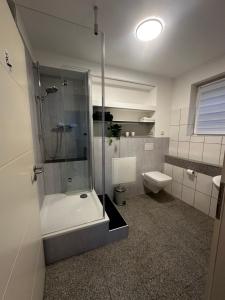 a bathroom with a shower and a toilet at FEWO Lohmar in Lohmar