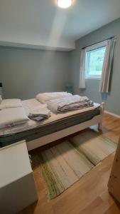 a bed sitting in a room with a window at Signegarden Bismo in Skjåk