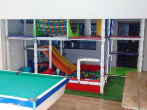 a childrens play area with a pool table at Hotel Colorado in Vilhena