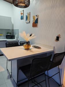 a kitchen with a table with a vase on it at Casa Congo Puerto Viejo in Puerto Viejo