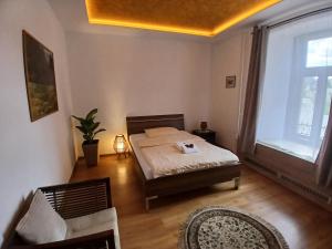 a bedroom with a bed and a large window at Hotel Panský Dům Žamberk in Žamberk