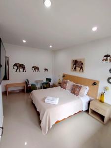a bedroom with a large bed in a room at Hotel River City in Montería