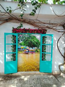 an open door with a painting of a river at Hotel River City in Montería +7 photos
