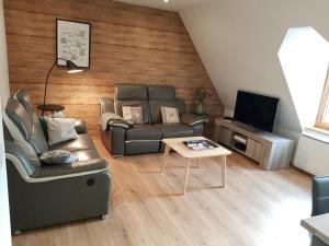 a living room with a couch and a table at Les Toits d'Hélène in Ammerschwihr
