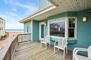 a blue house with two chairs on a deck at CAC-3A - Clownfish in Buxton