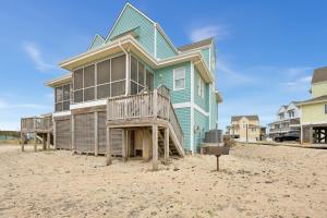 a blue house on the beach with a deck at CAC-3A - Clownfish in Buxton