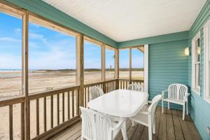 a dining room with a table and chairs on the beach at CAC-3A - Clownfish in Buxton