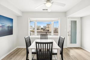 a dining room with a white table and chairs and a window at CAC-3A - Clownfish in Buxton +30 photos