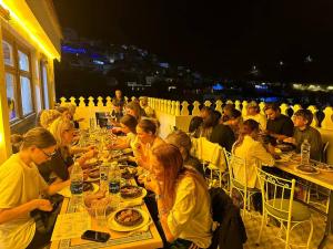 a group of people sitting at tables eating food at Ahlan Riad Chefchaouen in Chefchaouen